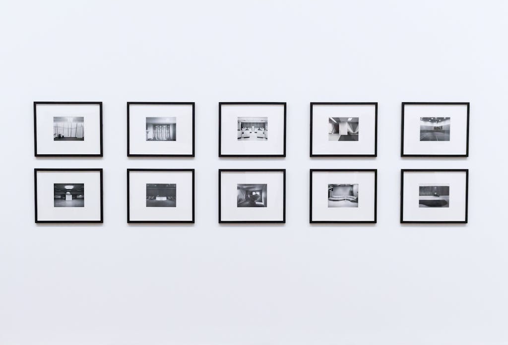 Simple and elegant wall display with black and white framed photographs in a modern interior.